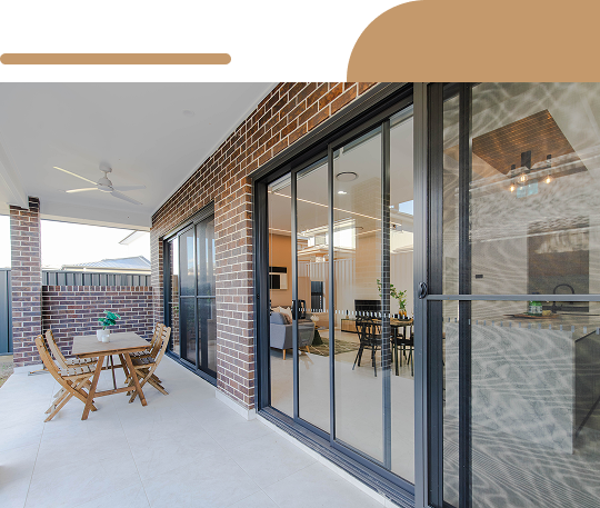 Modern outdoor patio with wood deck and glass doors